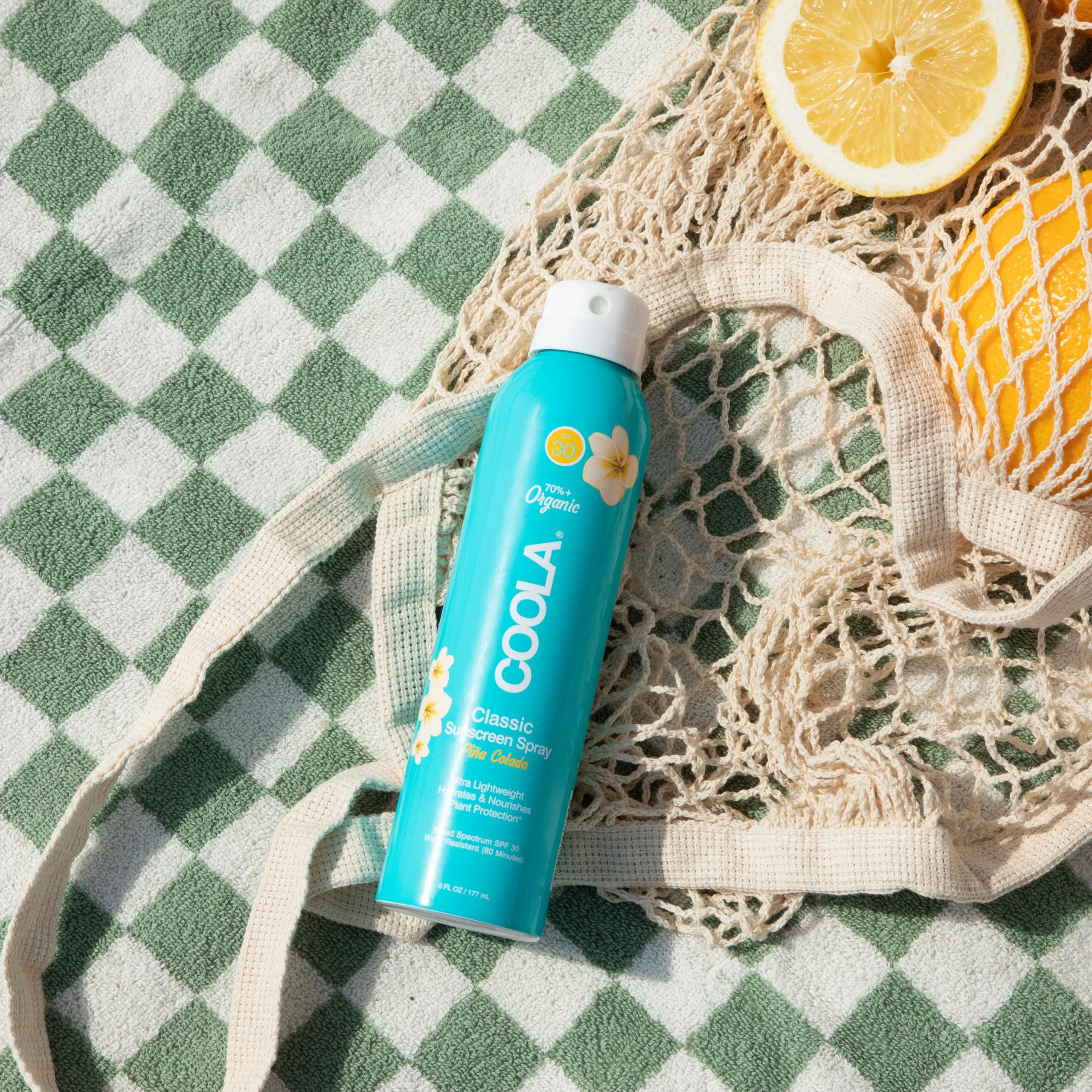 an image of the pina colada sun screen on a checkered blanket