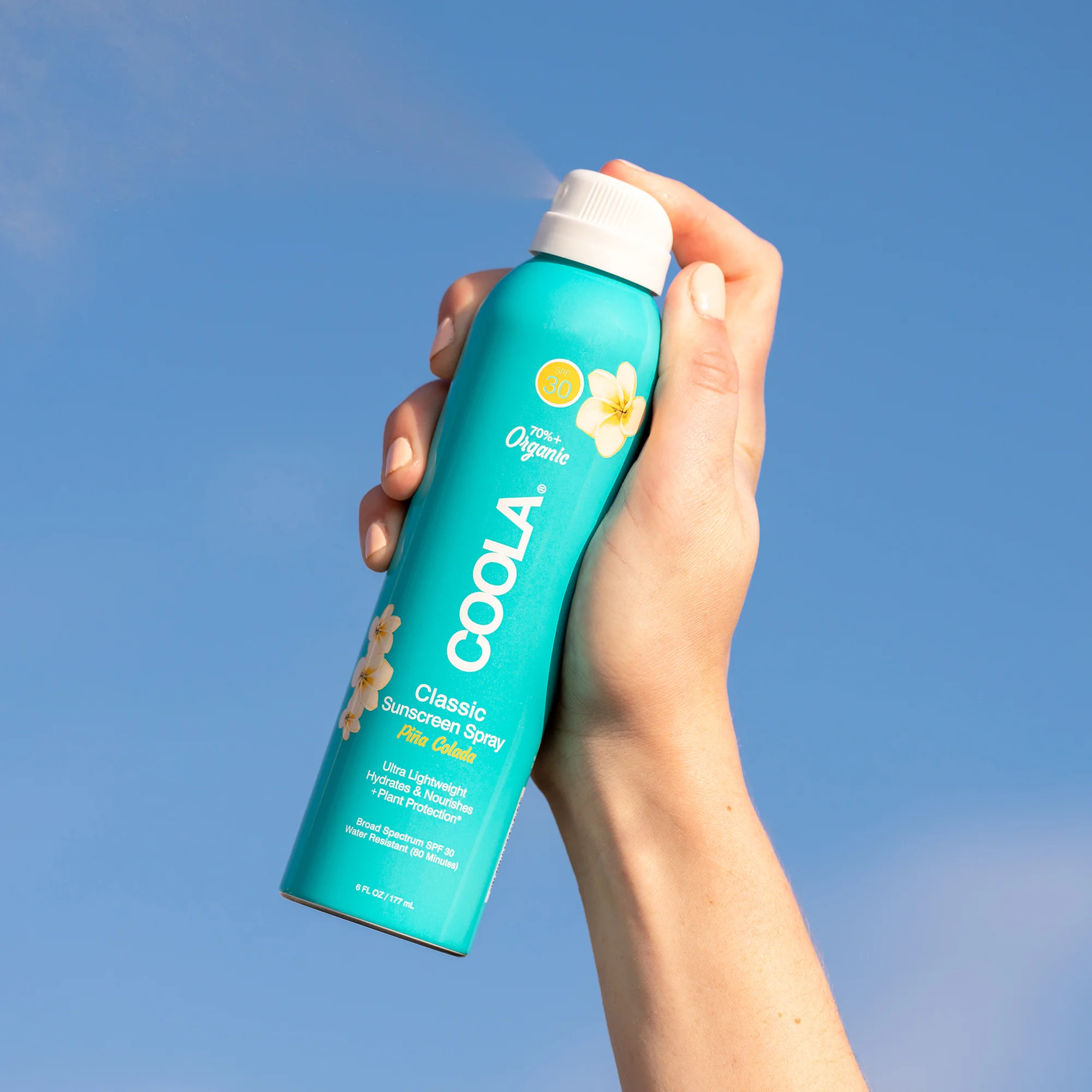 an image of the pina colada spray on a blue background.
