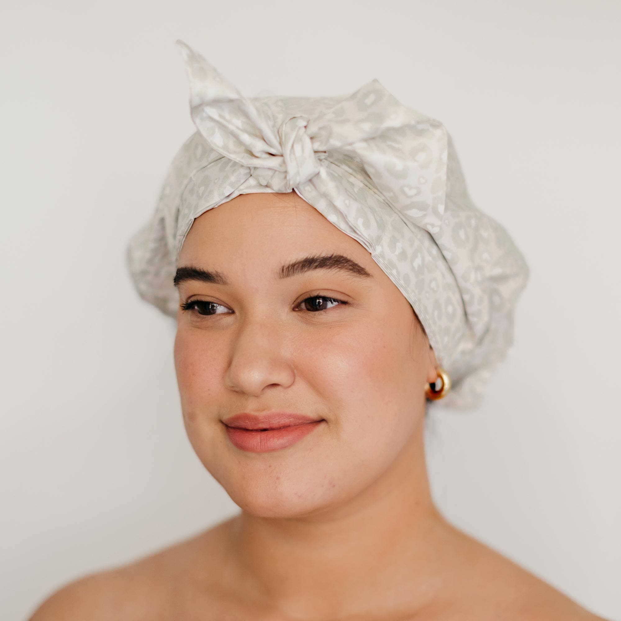 a girl wearing the shower cap from Pomme Salon
