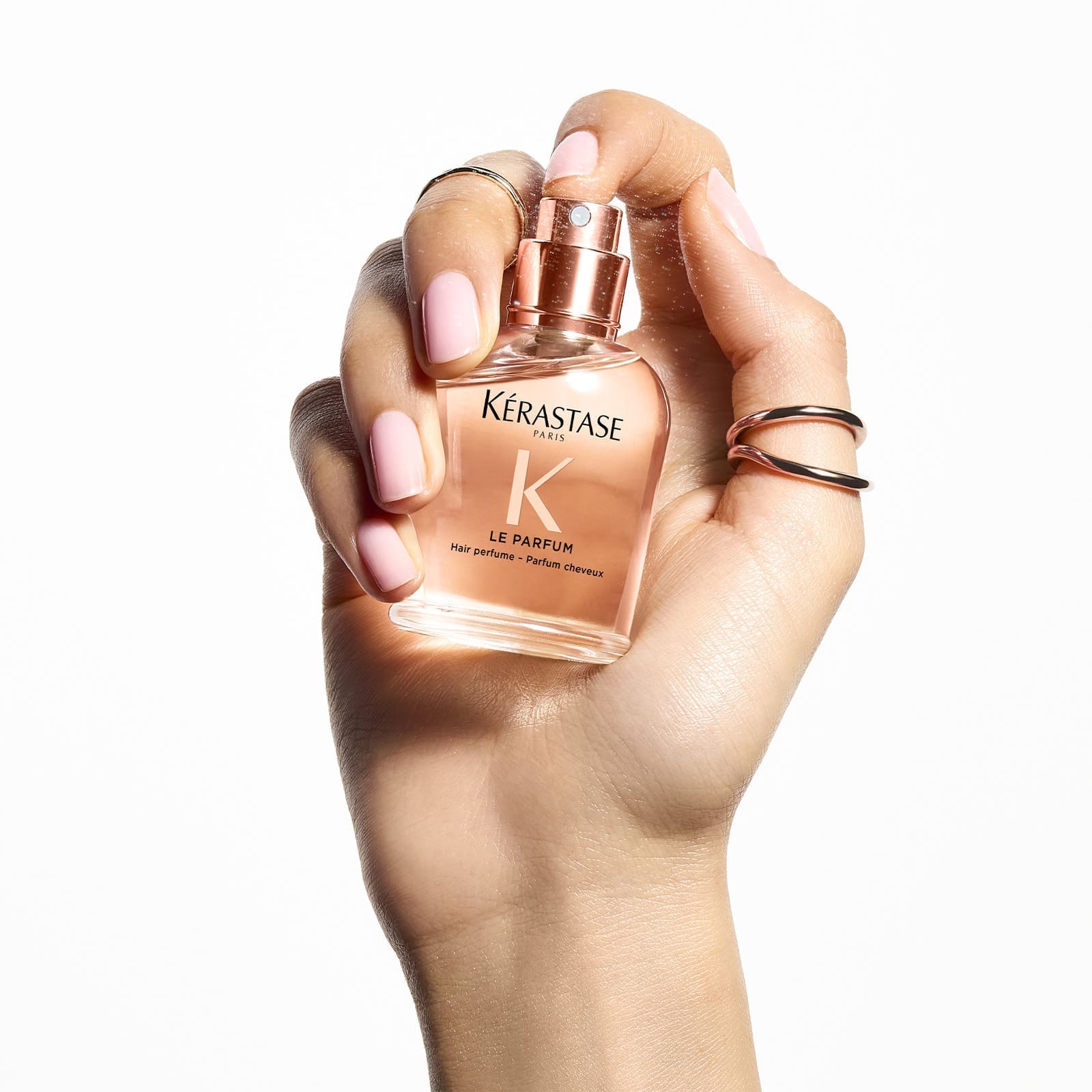 glass perfum bottle 30ml, in hand being sprayed